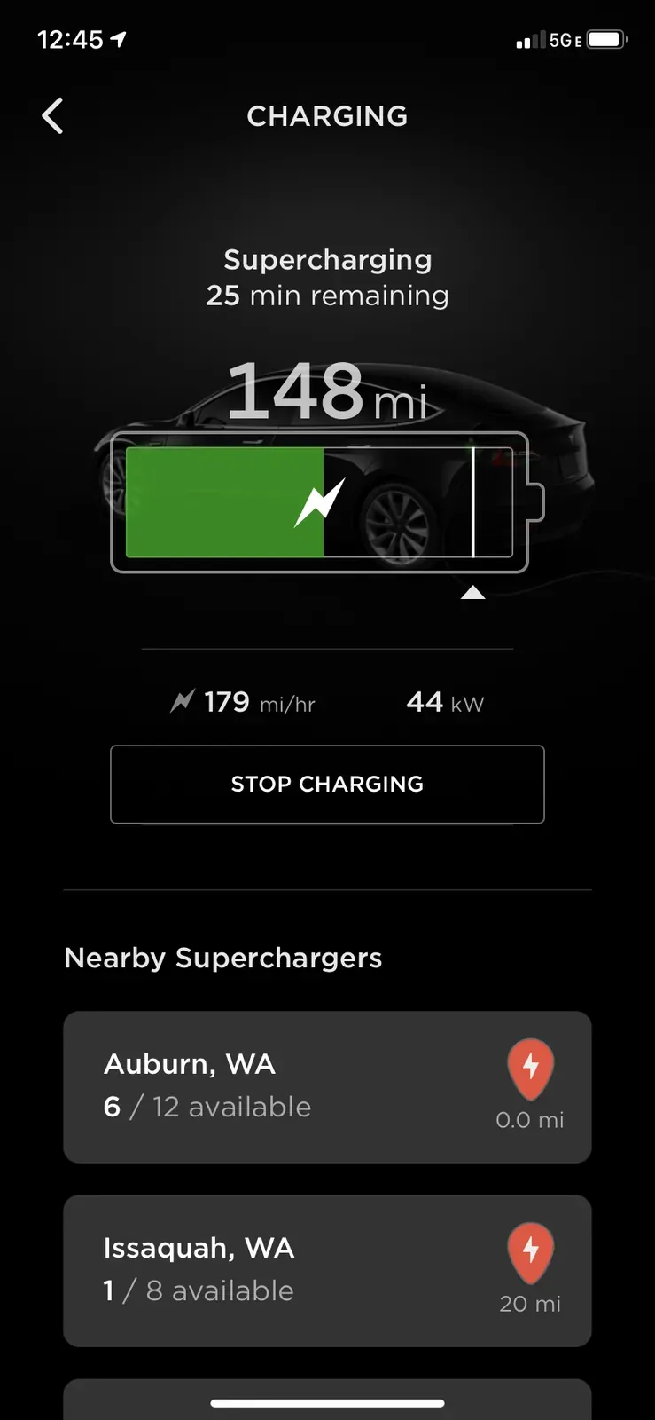 Tesla app showing a Supercharging session with time remaining and range added