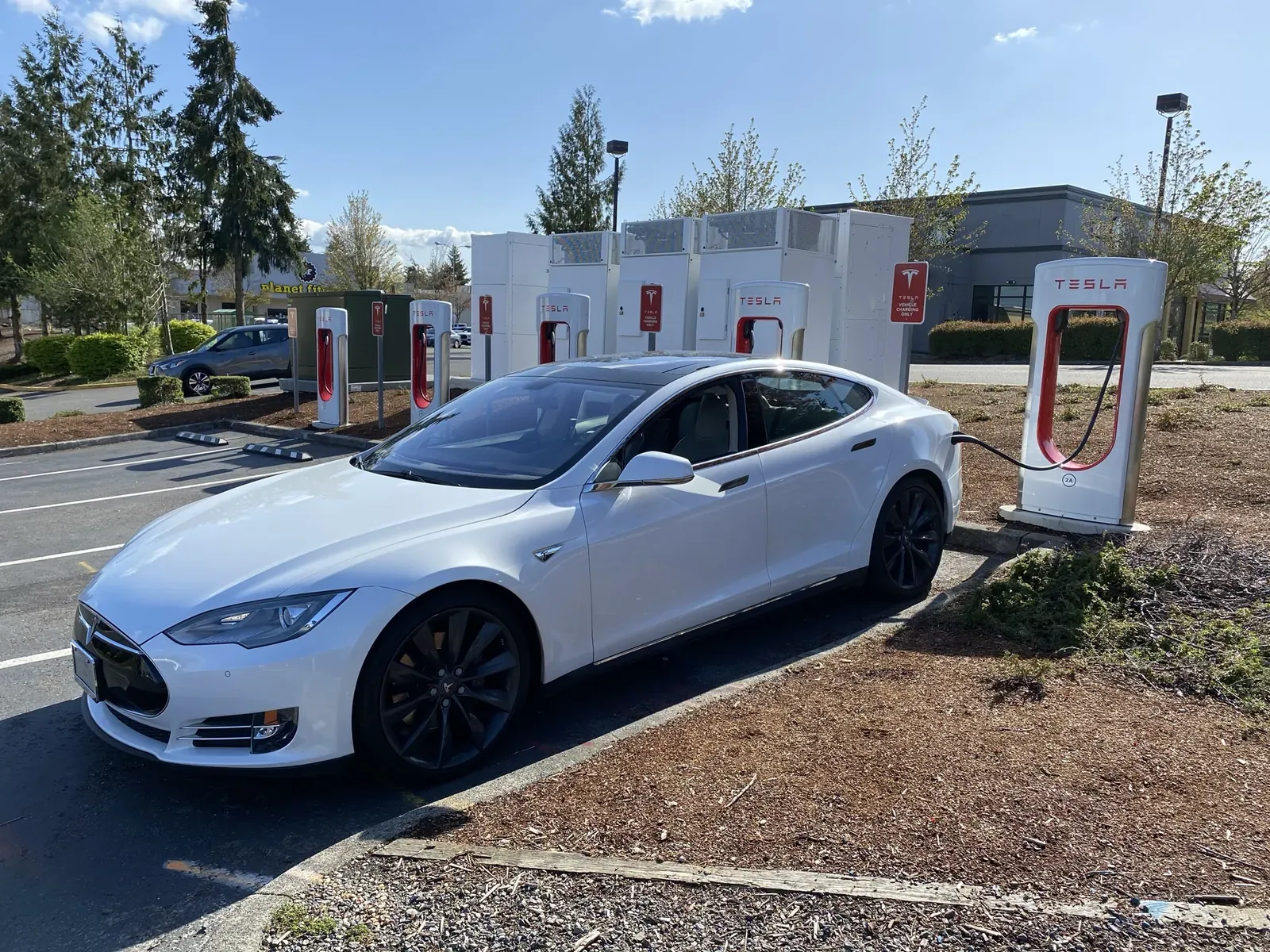 White Model S plugged into a Supercharger
