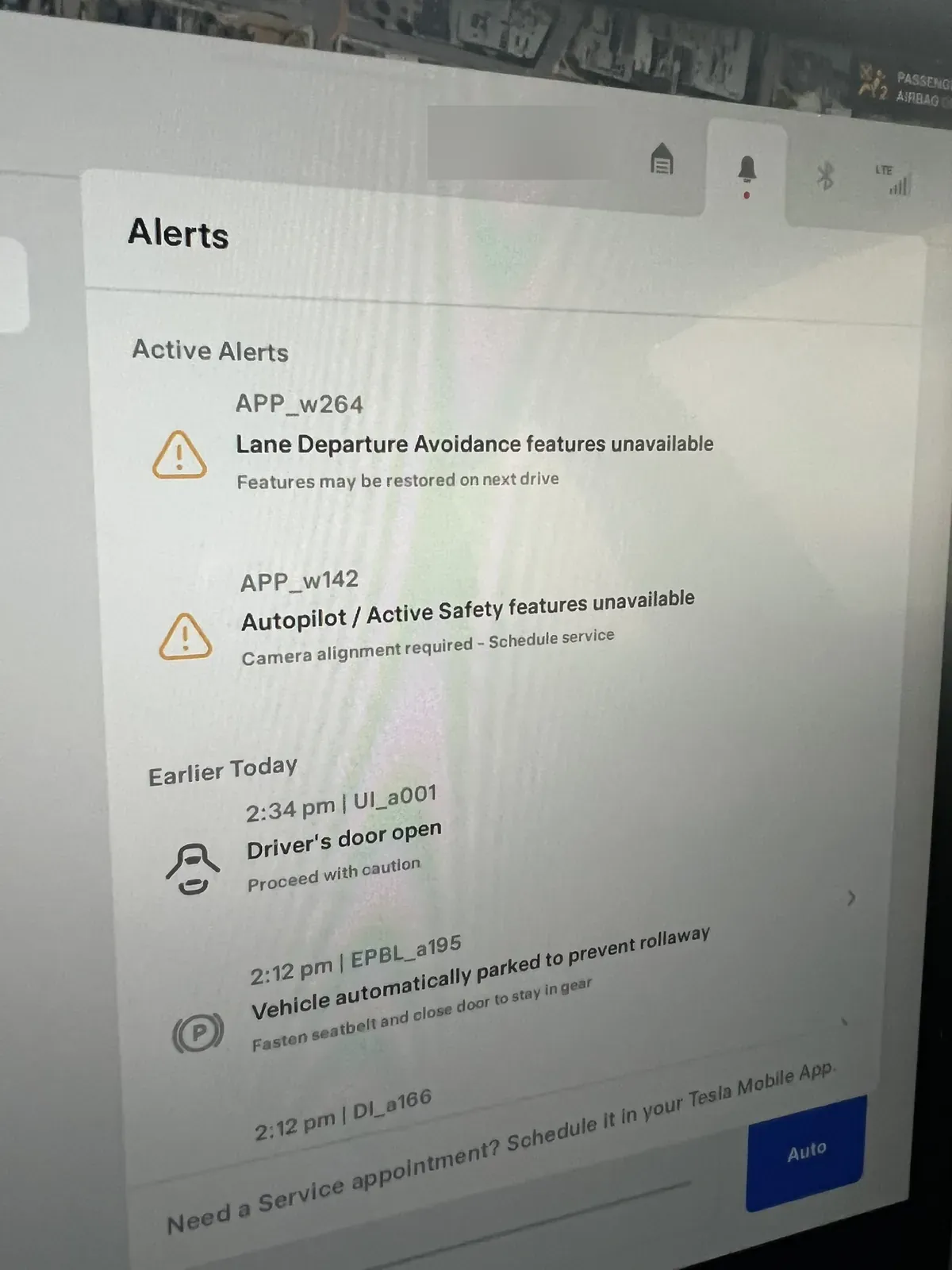Tesla alerts list showing Lane Departure Avoidance unavailable and camera alignment required