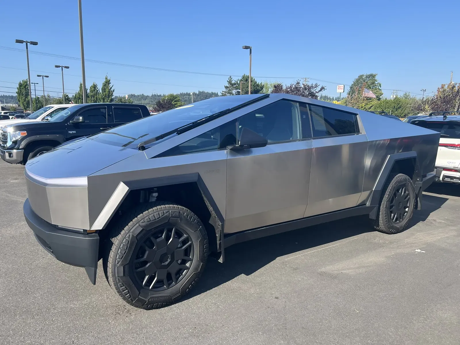 Stainless Cybertruck parked in the sun
