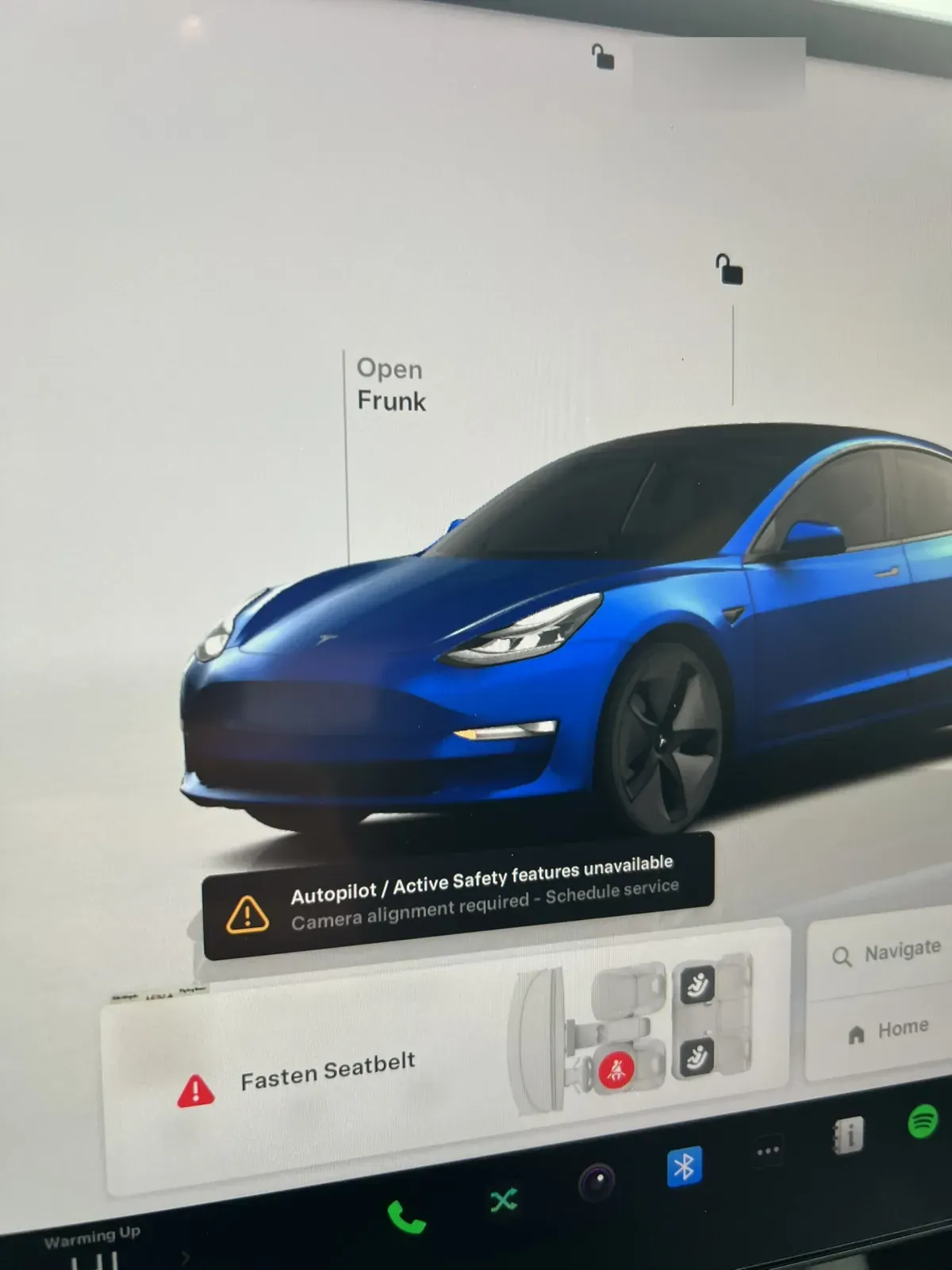 Model 3 screen showing frunk open and a camera alignment required alert (profile name blurred)